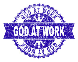 GOD AT WORK rosette stamp seal watermark with distress texture. Designed with round rosette, ribbon and small crowns. Blue vector rubber watermark of GOD AT WORK caption with dust texture.