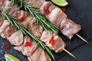 Raw kebabs marinated with rosemary and spices. Fresh juicy meat.