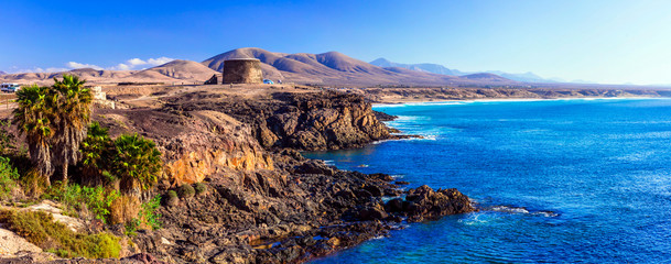 landscapes of volcanic Fuerteventura - view with Toston tower in El Cotillo. Canary islands - obrazy, fototapety, plakaty