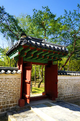 Seoul, South Korea - April 2018: Wooden gate and stone wall in Jongmyo Shrine.