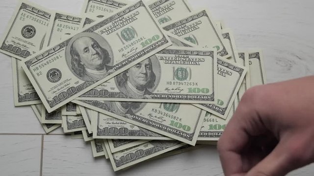 Timelapse of Man counts money. Dollars in hand, money in hand, counts the money