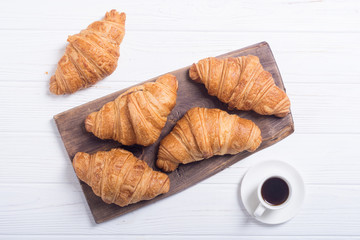 Croissants on wooden background