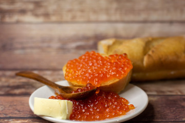 baguette sandwich with red caviar and butter.
