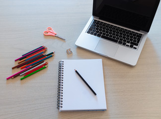 Trabajo de arte con colores y laptop para dibujar a color en papel blanco sobre mesa