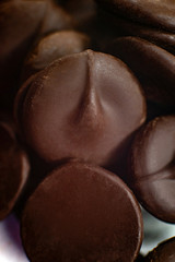 round pieces of chocolate for making chocolate glaze. macro.