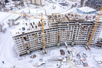 construction site in winter, aerial top view. building of new residential area