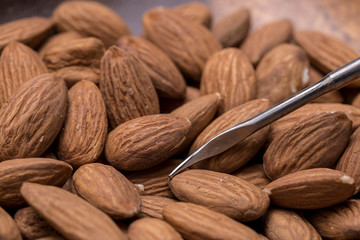 Raw almonds and a pick.