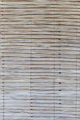 Dry sheet curtain tied with light wood tone background.