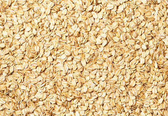 Dry raw oat flakes close-up, oat background