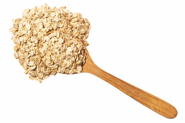 Uncooked oatmeal in  wooden  spoon isolated on white top view