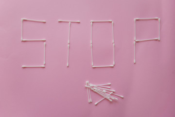 ban on plastic cotton swabs, the word "STOP" from plastic cotton swabs, flat lay, view from above