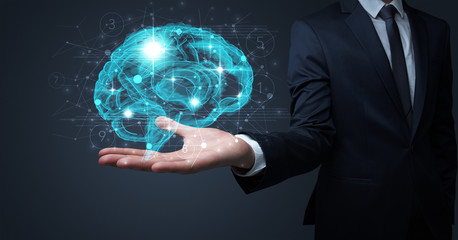 Businessman holding human brain on his hand with logistics symbols around