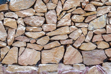 Fragment of a wall from a colour chipped stone background texture photo