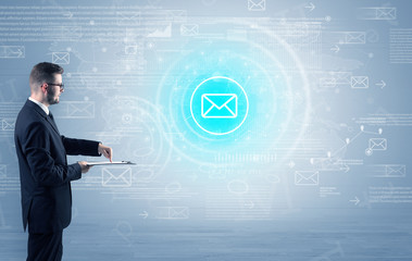 Standing businessman with data around and highlighted icon on the centre
