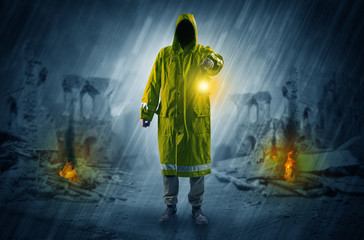 Destroyed place after a catastrophe with man in raincoat and lantern concept
