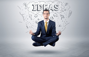 Businessman sitting in yoga position and meditates with doodle concept
