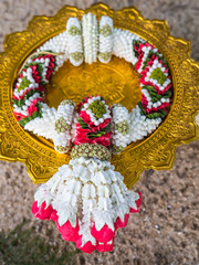 Garland, lei of flowers for worship on tray