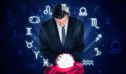 Young handsome astronaut looking for inspiration in his crystal magic ball

