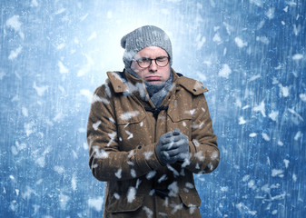 Handsome young boy shivering and trembling at snowstorm concept
