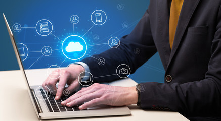 Businessman hand typing with cloud technology system and office symbol concept
