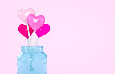 3d rendering. Sweet Valentine's day heart shape lollipop candy in blue glass jar with pink background. Love Concept. Minimalism colorful hipster style.