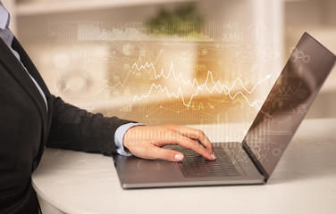 Business woman in homey environment using laptop with global financial report concept
