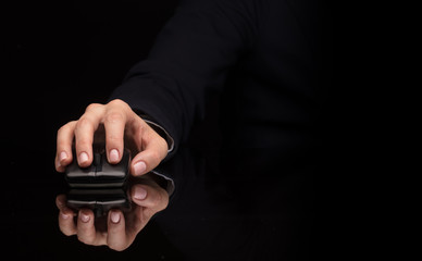 Fototapeta premium Hand using wireless mouse in a dark environment 