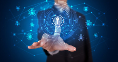 Man touching hologram screen displaying keys and locks