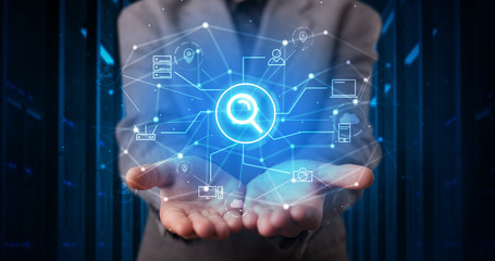 Man holding hologram projection displaying cloud technology symbols
