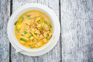 delicious yellow Thai curry on a wooden table