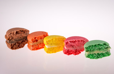 colored French macarons on white background