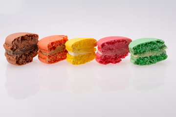 colored French macarons on white background