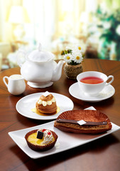 Delicious English afternoon tea set on a white background