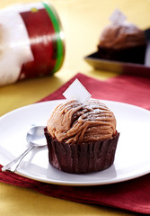 Delicious chestnut cupcakes over white background