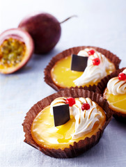 Delicious passion fruit tarts over white background