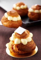 Delicious cream puffs on white background