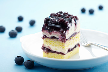 Delicate blueberry jam cake over white background