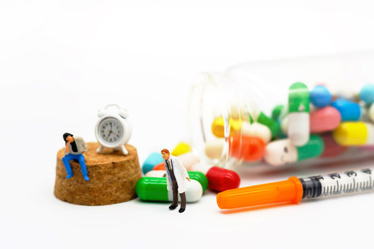 Miniature people: Patients sitting with drugs and clock. Health care and business concept.