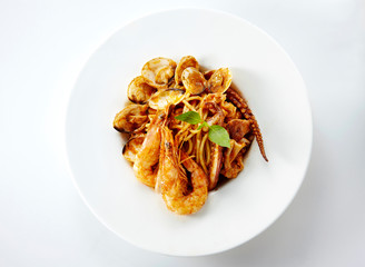 Delicious seafood pasta over white background