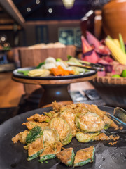 Fried eggs with climbing wattle and eggplant on table buffet