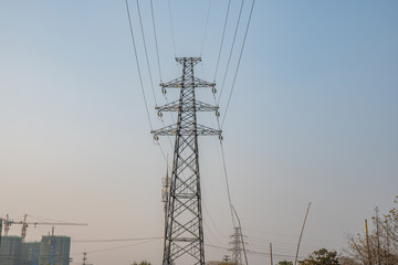 high voltage tower on background of blue sky