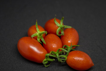 Fresh tomatoes on black background