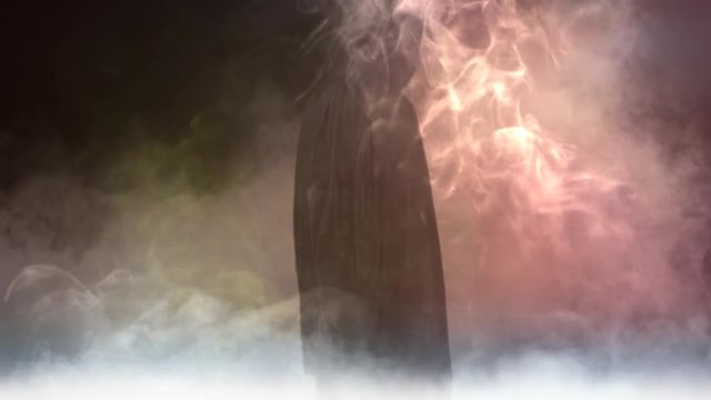 Black Masked Figure with Sword in Smoke 4K features a figure in a black hooded cape holding a large broadsword in an environment of smoke, fog, and mist.