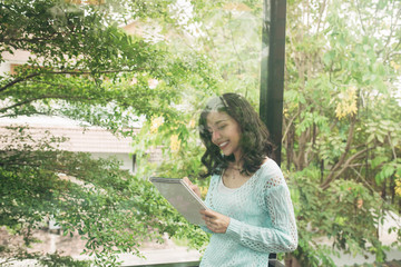 Naklejka premium Young attractive sweet girl with notepad on a veranda. Spring mood.