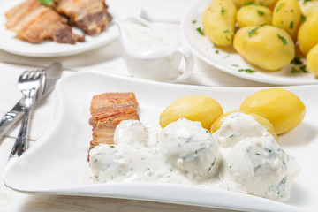 Roast pork belly with boiled potatoes and cream sauce