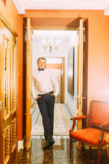 The preparations of the groom in a Deluxe hotel. the man in the shirt and jacket.