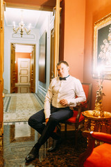 The preparations of the groom in a Deluxe hotel. the man in the shirt and jacket.