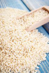 Heap of sesame seeds on wooden boards