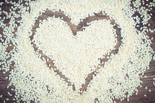 Vintage photo, Heart of sesame seeds on board, healthy nutrition concept and sumbol of love