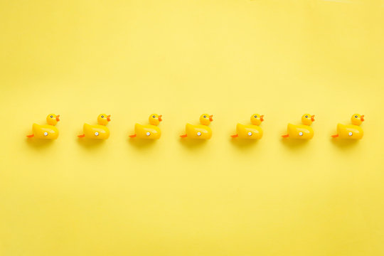 A roll of yellow duckies on yellow background,